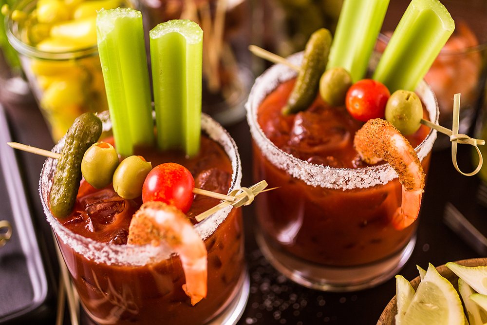 Texas Two Step Bloody Mary cocktail garnished with celery, olives, and shrimp